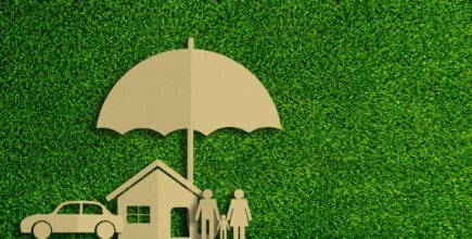 Paper cut of insurance concept on green grass background. Car insurance, life insurance, home insurance to protection by umbrella.