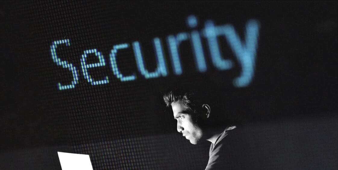 Man looking at computer screen with the word "Security" above him