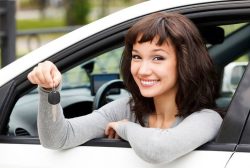 happy-girl-in-car-showing-key