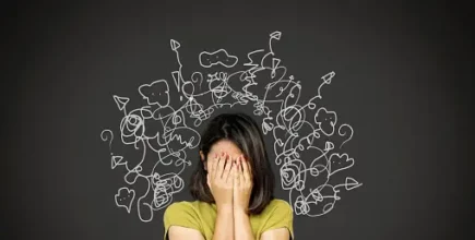 Woman covering face with scribbles around her head