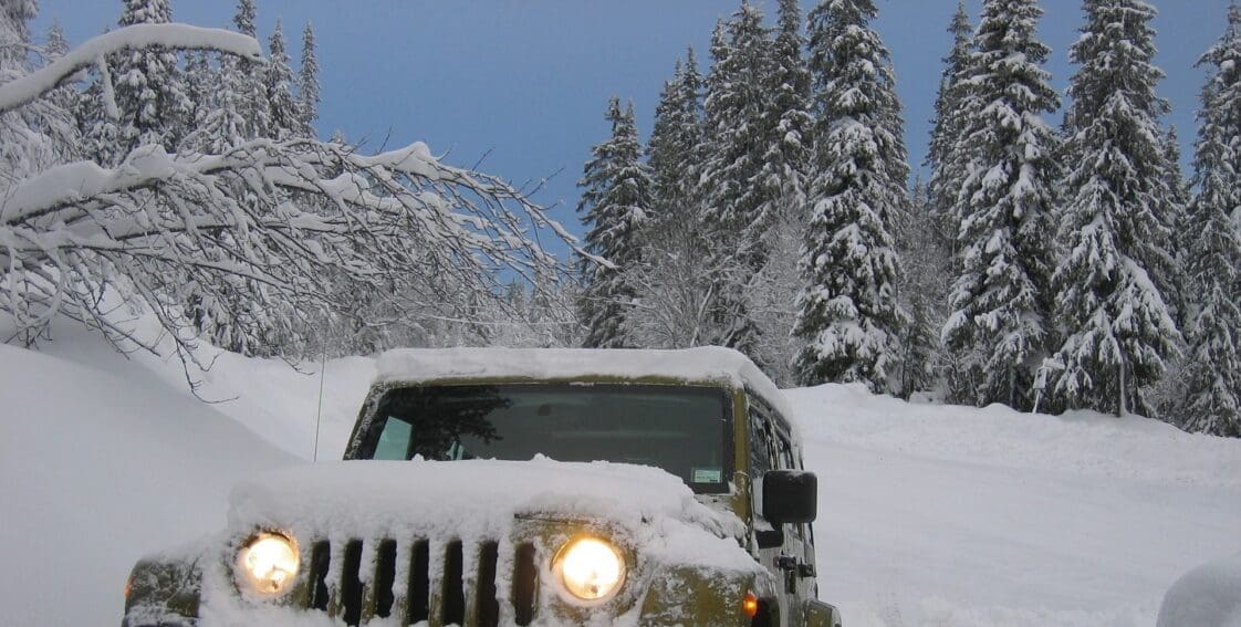 Jeep driving through snowy roads