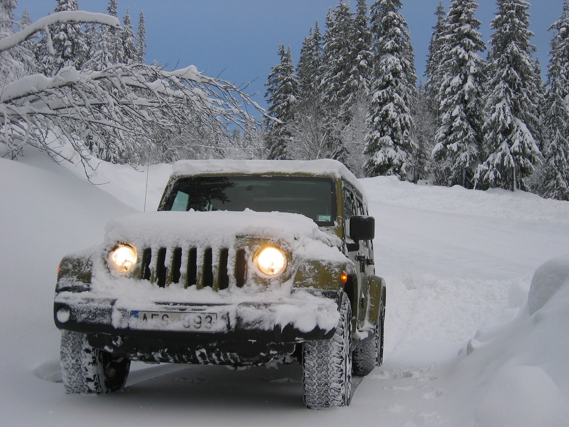 Jeep driving through snowy roads
