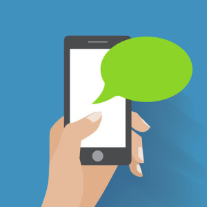 hand holing smartphone with blank speech bubble for text.