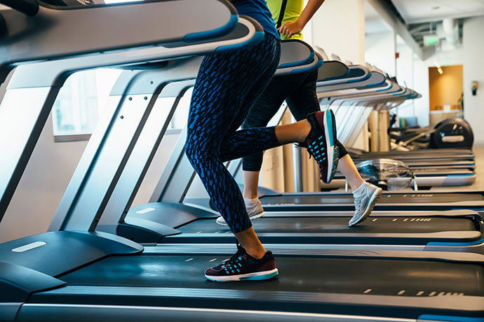 Group of women running on treadmills at a gym