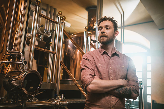 Man tasting fresh beer in a brewery