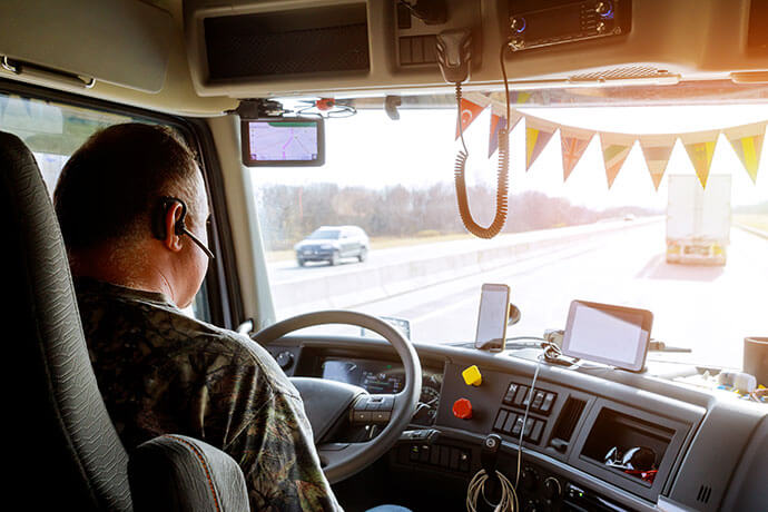 Driver in cabin of big modern truck