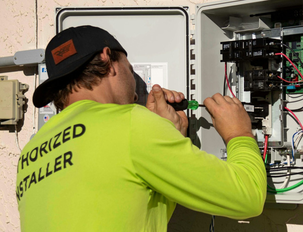 Electrician working on breaker box. Electrical contractor insurance