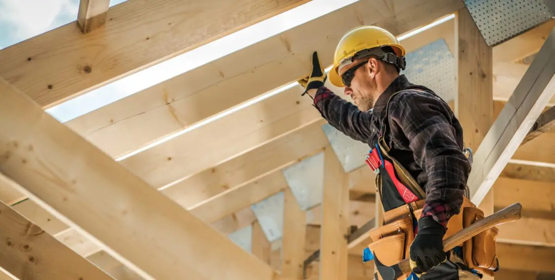 a contractor is working on a wooden frame