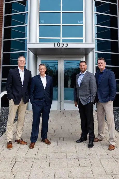 Partners in front of the building