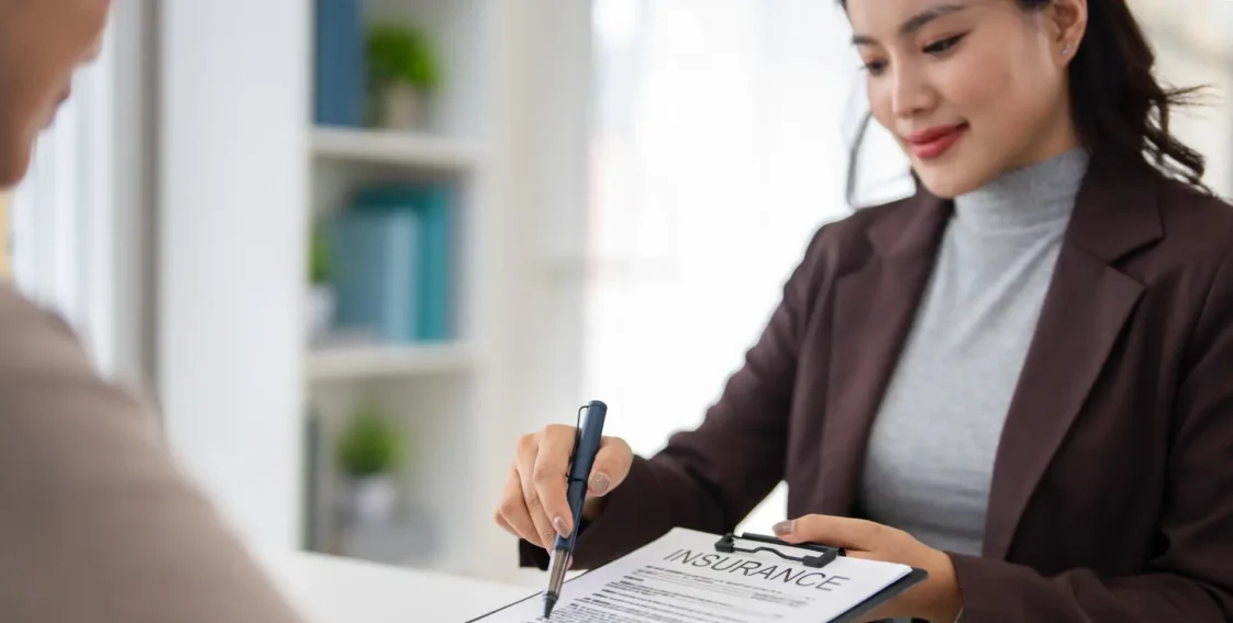 Insurance agent reviewing a policy with a client